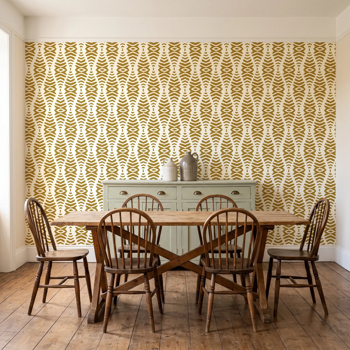 Smoke Ancestry Ochre geometric wallpaper in a farmhouse dining room with a sage sideboard and rustic trestle table