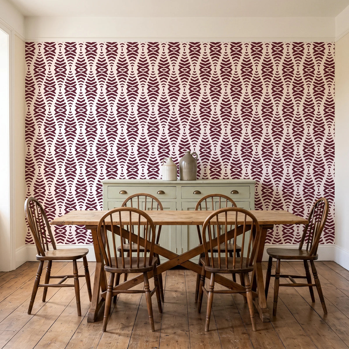 Smoke Ancestry Oxblood geometric wallpaper in a farmhouse dining room with a sage sideboard and rustic trestle table