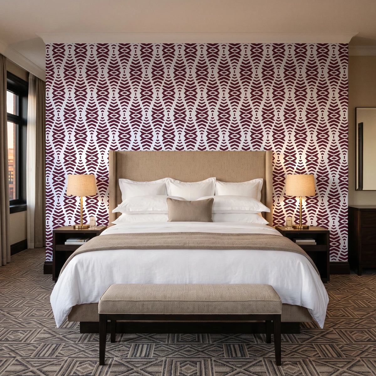 Smoke Ancestry Oxblood geometric wallpaper behind the headboard of a king bed in a contemporary hotel guest room