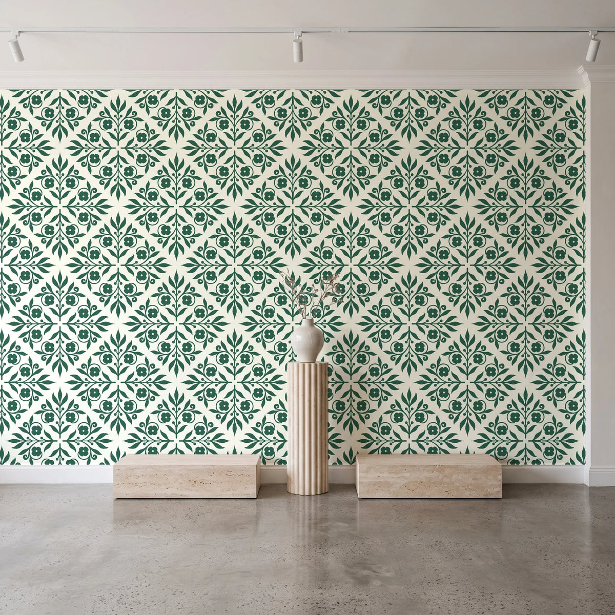 Soft Bouquet Opus Emerald floral damask wallpaper behind a travertine pedestal and vase in a minimal boutique