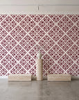 Soft Bouquet Opus Oxblood floral damask wallpaper behind a travertine pedestal and vase in a minimal boutique