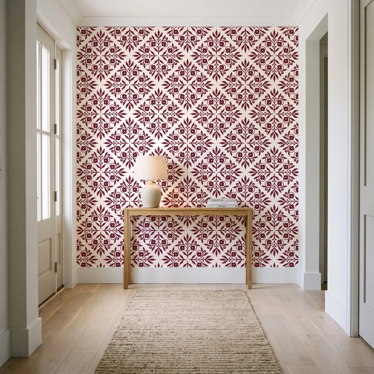 Soft Bouquet Opus Oxblood floral damask wallpaper behind a console table in a light entry hallway