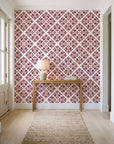 Soft Bouquet Opus Oxblood floral damask wallpaper behind a console table in a light entry hallway