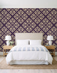 Soft Bouquet Opus Plum floral damask wallpaper behind a queen bed in a bright coastal bedroom