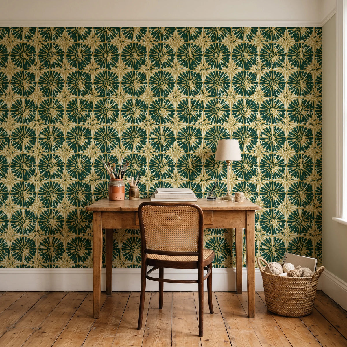 Solar Ritual Emerald floral wallpaper behind a vintage writing desk in a cozy craft-room home office