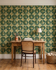 Solar Ritual Emerald floral wallpaper behind a vintage writing desk in a cozy craft-room home office