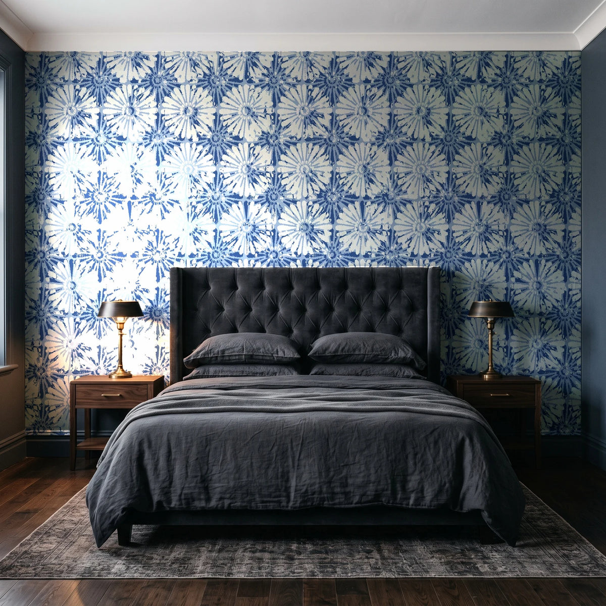 Solar Ritual Indigo floral wallpaper behind a tufted headboard in a dark, moody bedroom