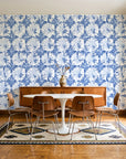 Solar Ritual Indigo floral wallpaper in a mid-century dining room with a teak sideboard and tulip table