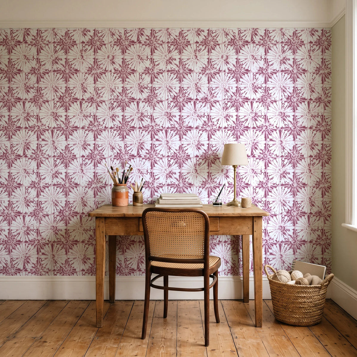 Solar Ritual Rosewood floral wallpaper behind a vintage writing desk in a cozy craft-room home office