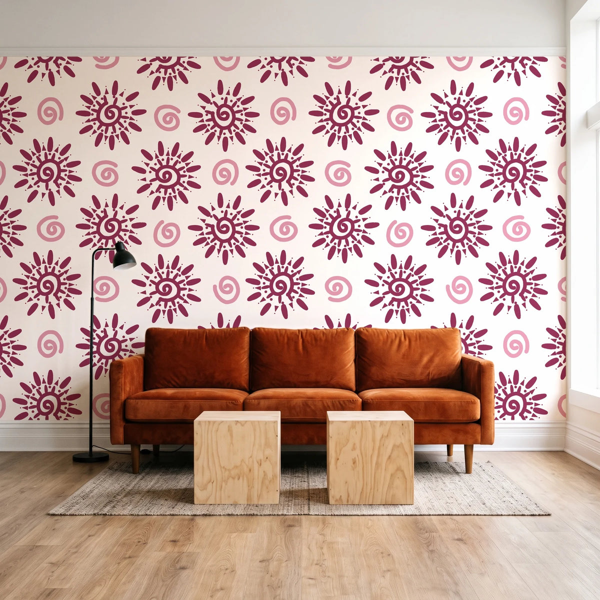 Solstice Bloom Berry folk sun wallpaper behind a rust velvet sofa in a bright coworking lounge