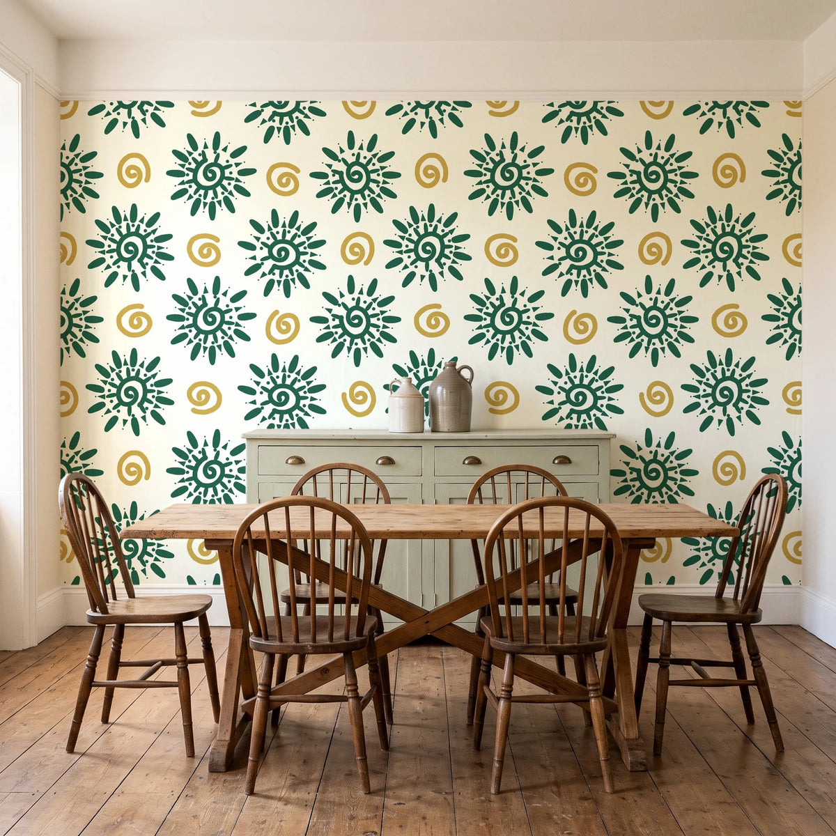 Solstice Bloom Emerald folk sun wallpaper in a farmhouse dining room with a sage sideboard and rustic trestle table