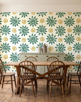 Solstice Bloom Emerald folk sun wallpaper in a farmhouse dining room with a sage sideboard and rustic trestle table