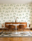Solstice Rite Forest boho rainbow wallpaper in a mid-century dining room with a teak sideboard and tulip table