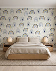 Solstice Rite Midnight boho rainbow wallpaper behind a low platform bed in a serene Japandi bedroom
