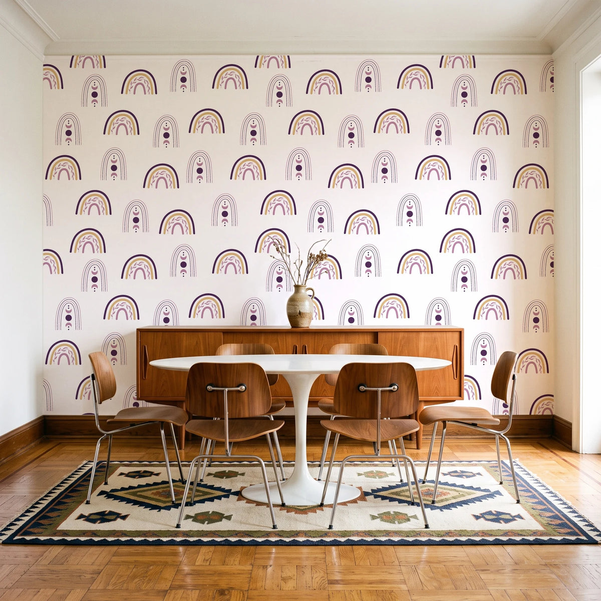 Solstice Rite Plum boho rainbow wallpaper in a mid-century dining room with a teak sideboard and tulip table