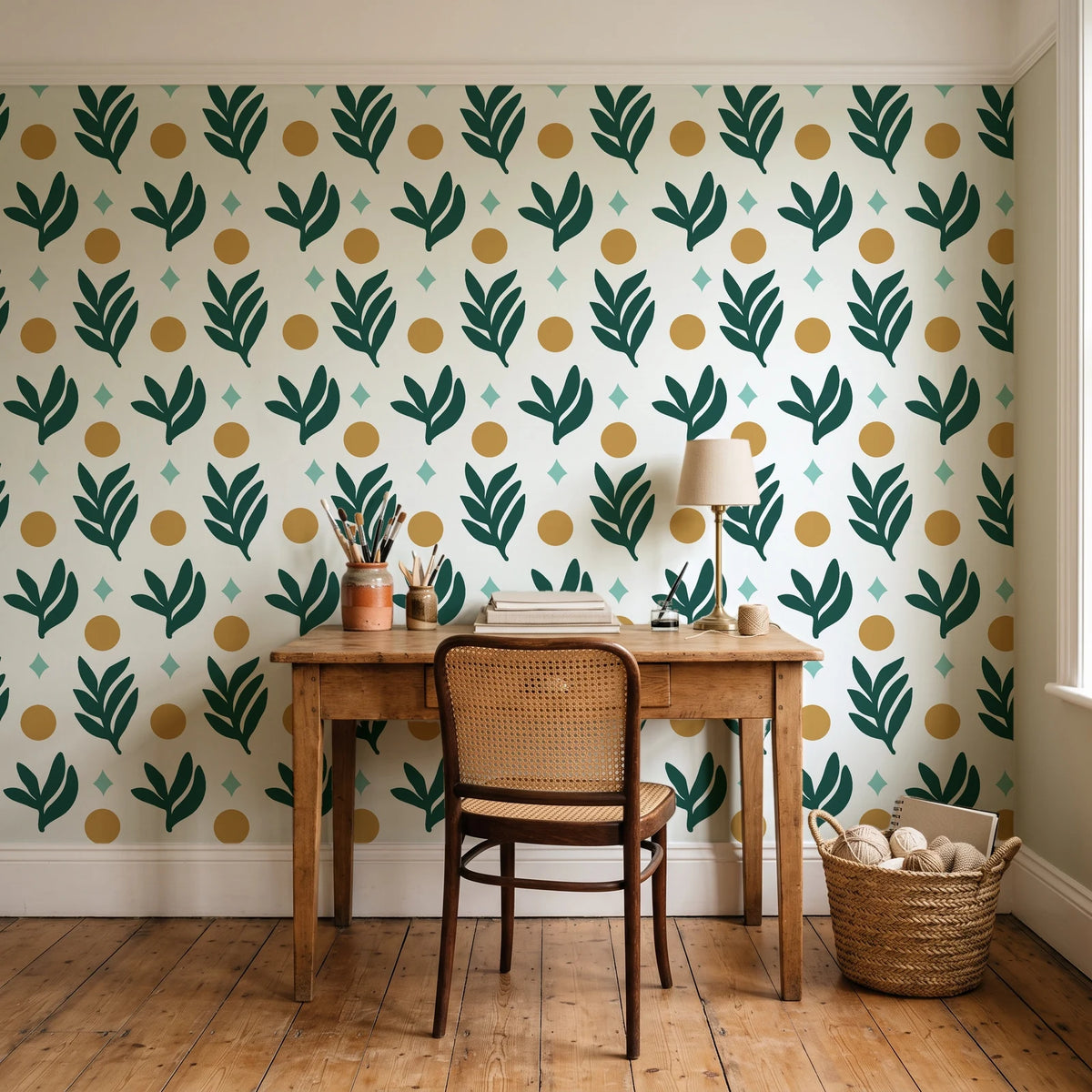 Spice & Frond Emerald leaf frond wallpaper behind a vintage writing desk in a cozy craft-room home office