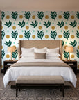 Spice & Frond Emerald leaf frond wallpaper behind the headboard of a king bed in a contemporary hotel guest room