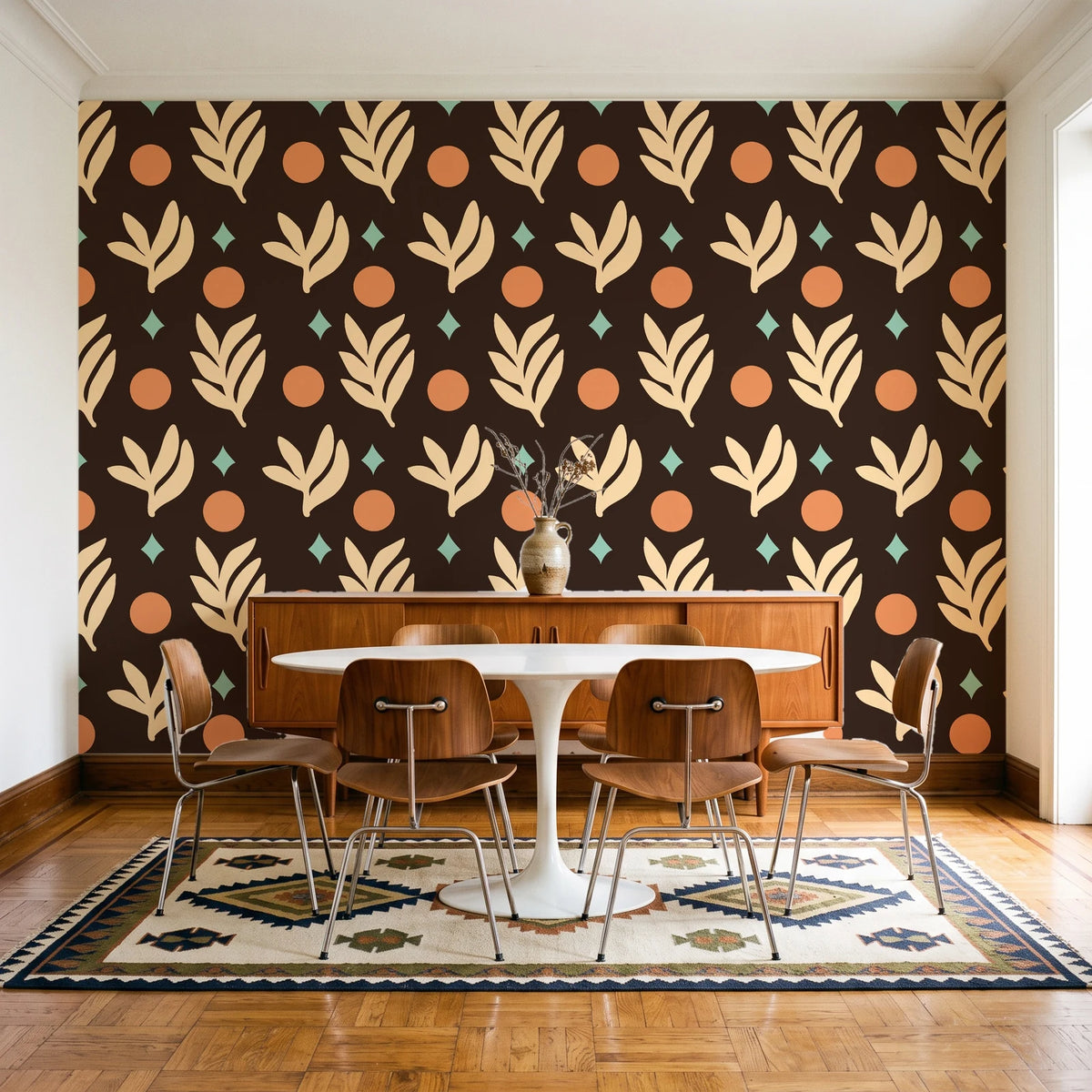 Spice & Frond Espresso leaf frond wallpaper in a mid-century dining room with a teak sideboard and tulip table