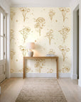 Star & Petal Ochre wildflower line art wallpaper behind a console table in a light entry hallway