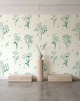 Stardust Field Emerald wildflower line art wallpaper behind a travertine pedestal and vase in a minimal boutique