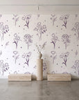 Stardust Field Plum wildflower line art wallpaper behind a travertine pedestal and vase in a minimal boutique