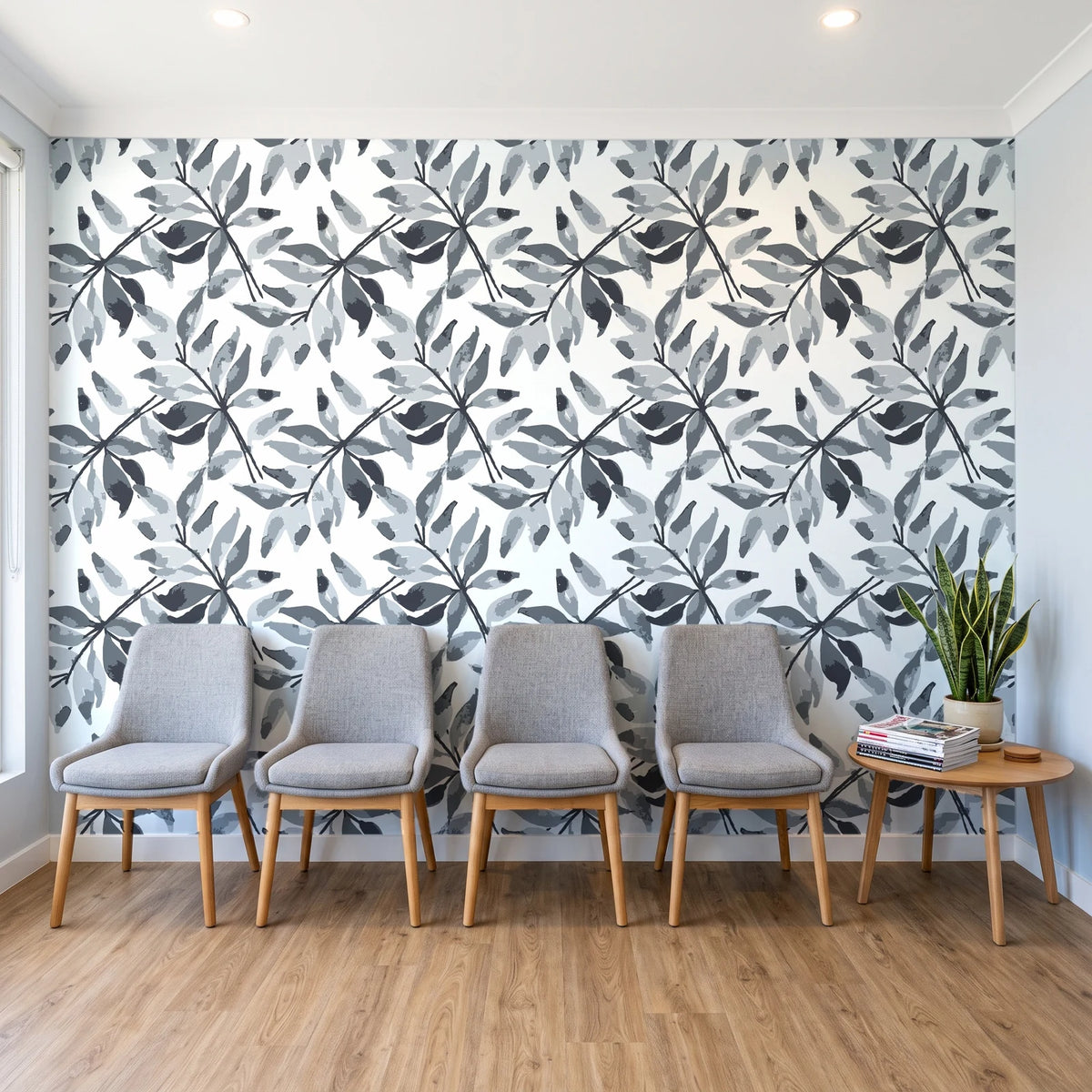 Starfall Charcoal watercolor leaf wallpaper behind a row of upholstered chairs in a bright clinic waiting room