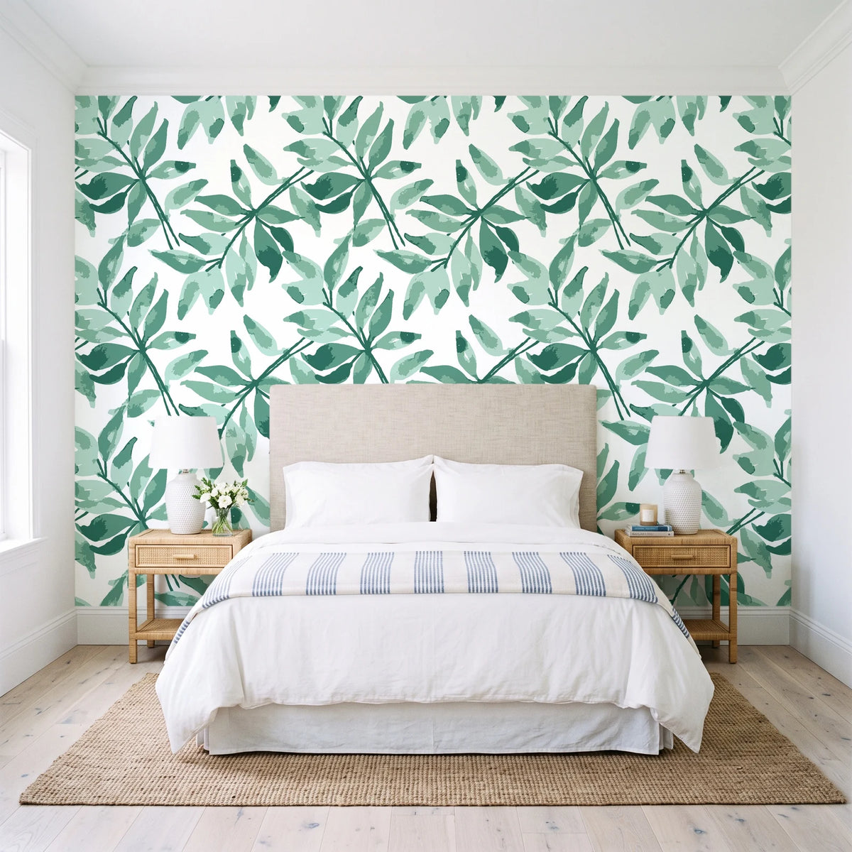 Starfall Emerald watercolor leaf wallpaper behind a queen bed in a bright coastal bedroom