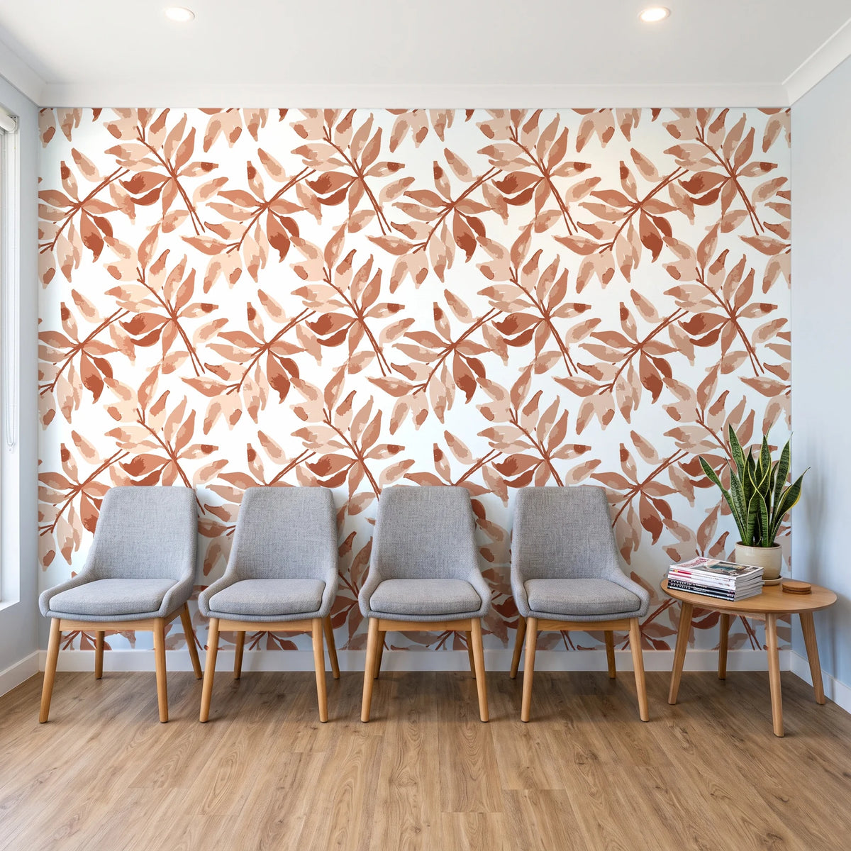 Starfall Terracotta watercolor leaf wallpaper behind a row of upholstered chairs in a bright clinic waiting room