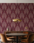 Starlit Swirl Oxblood dotted art deco fan wallpaper behind a walnut credenza and round table in an elegant dining room