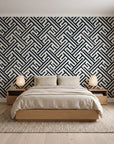 Still Labyrinth Ink maze geometric wallpaper behind a low platform bed in a serene Japandi bedroom