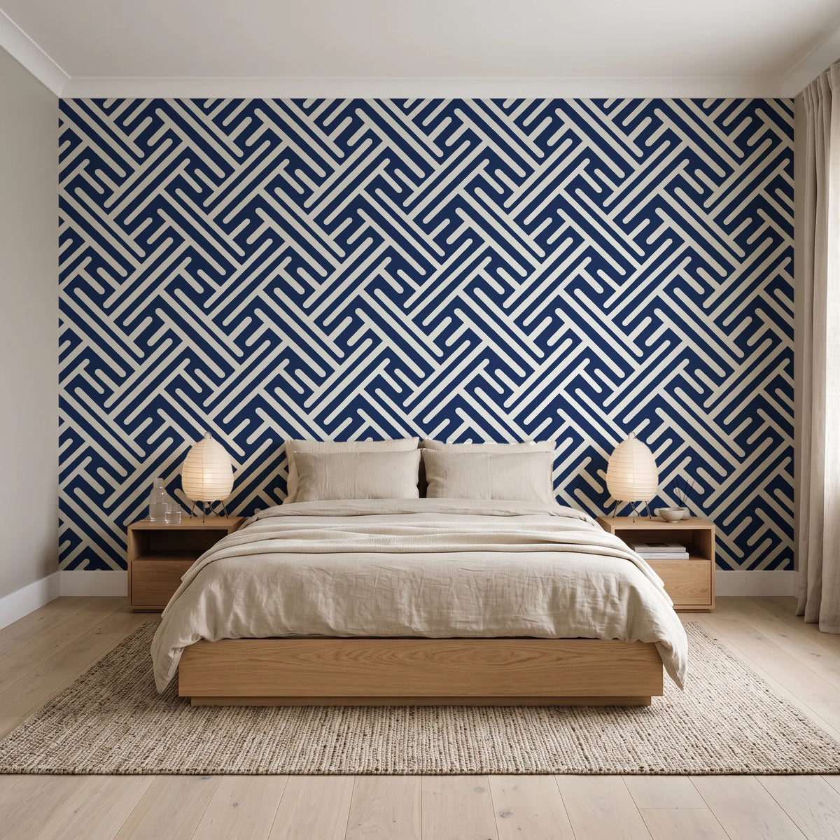 Still Labyrinth Navy maze geometric wallpaper behind a low platform bed in a serene Japandi bedroom