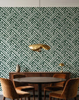 Still Labyrinth Pine maze geometric wallpaper behind a walnut credenza and round table in an elegant dining room