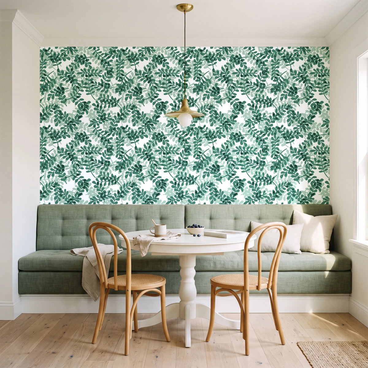 Still Morning Emerald foliage wallpaper as a feature wall in a sunlit breakfast nook