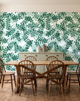 Still Morning Emerald foliage wallpaper in a farmhouse dining room with a sage sideboard and rustic trestle table
