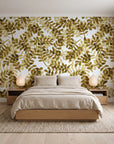 Still Morning Ochre foliage wallpaper behind a low platform bed in a serene Japandi bedroom