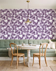 Still Morning Plum foliage wallpaper as a feature wall in a sunlit breakfast nook