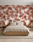 Still Morning Terracotta foliage wallpaper behind a low platform bed in a serene Japandi bedroom