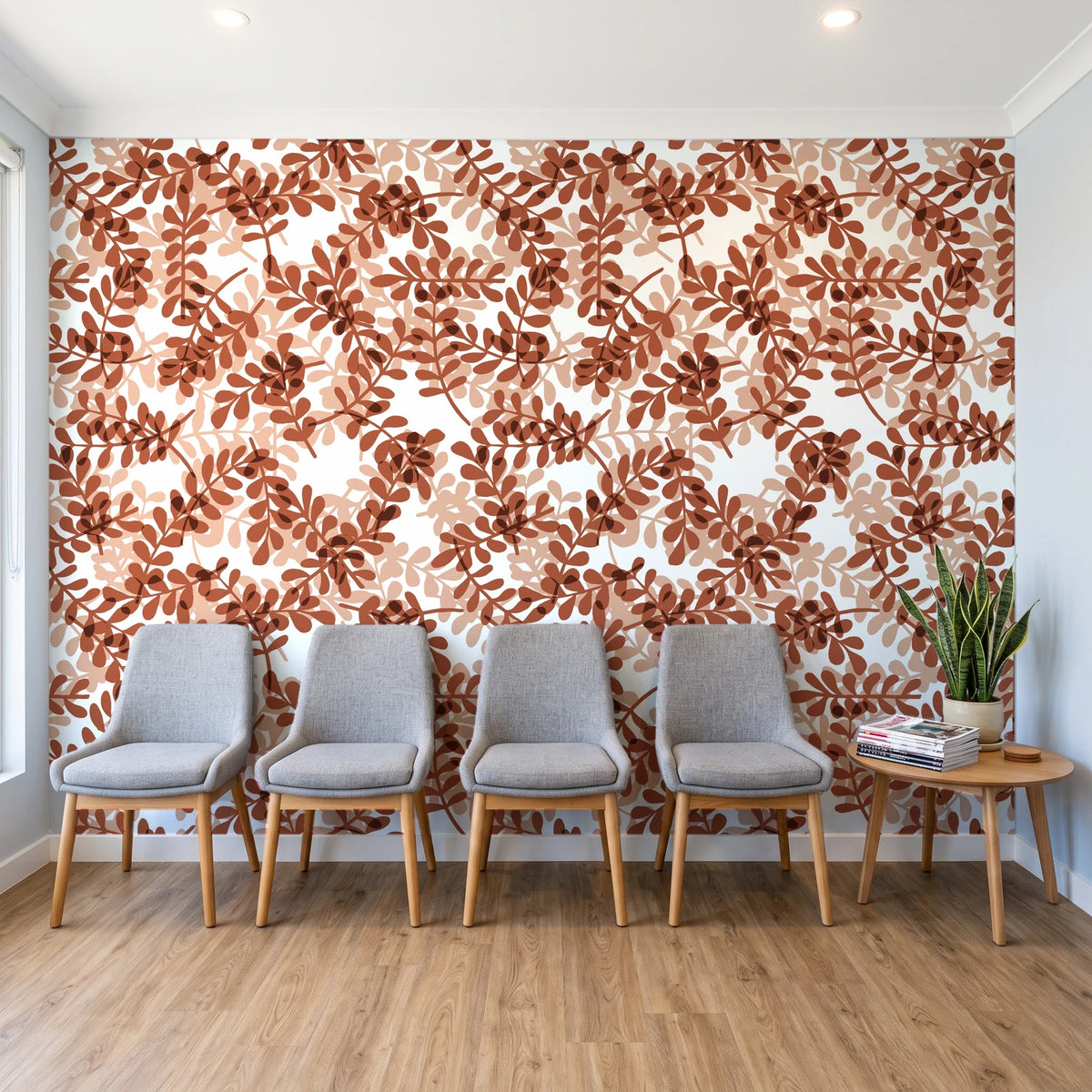 Still Morning Terracotta foliage wallpaper behind a row of upholstered chairs in a bright clinic waiting room