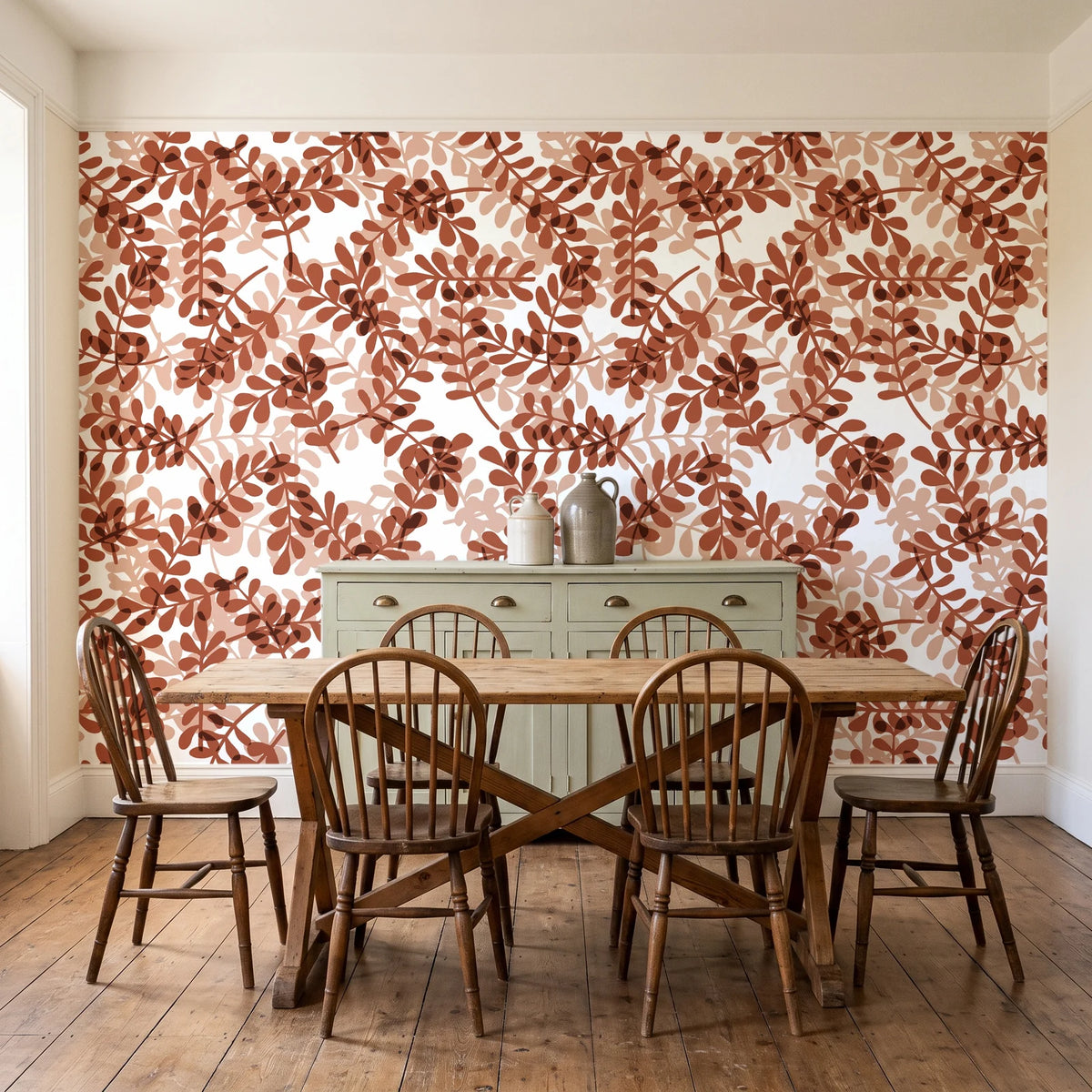 Still Morning Terracotta foliage wallpaper in a farmhouse dining room with a sage sideboard and rustic trestle table