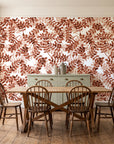 Still Morning Terracotta foliage wallpaper in a farmhouse dining room with a sage sideboard and rustic trestle table