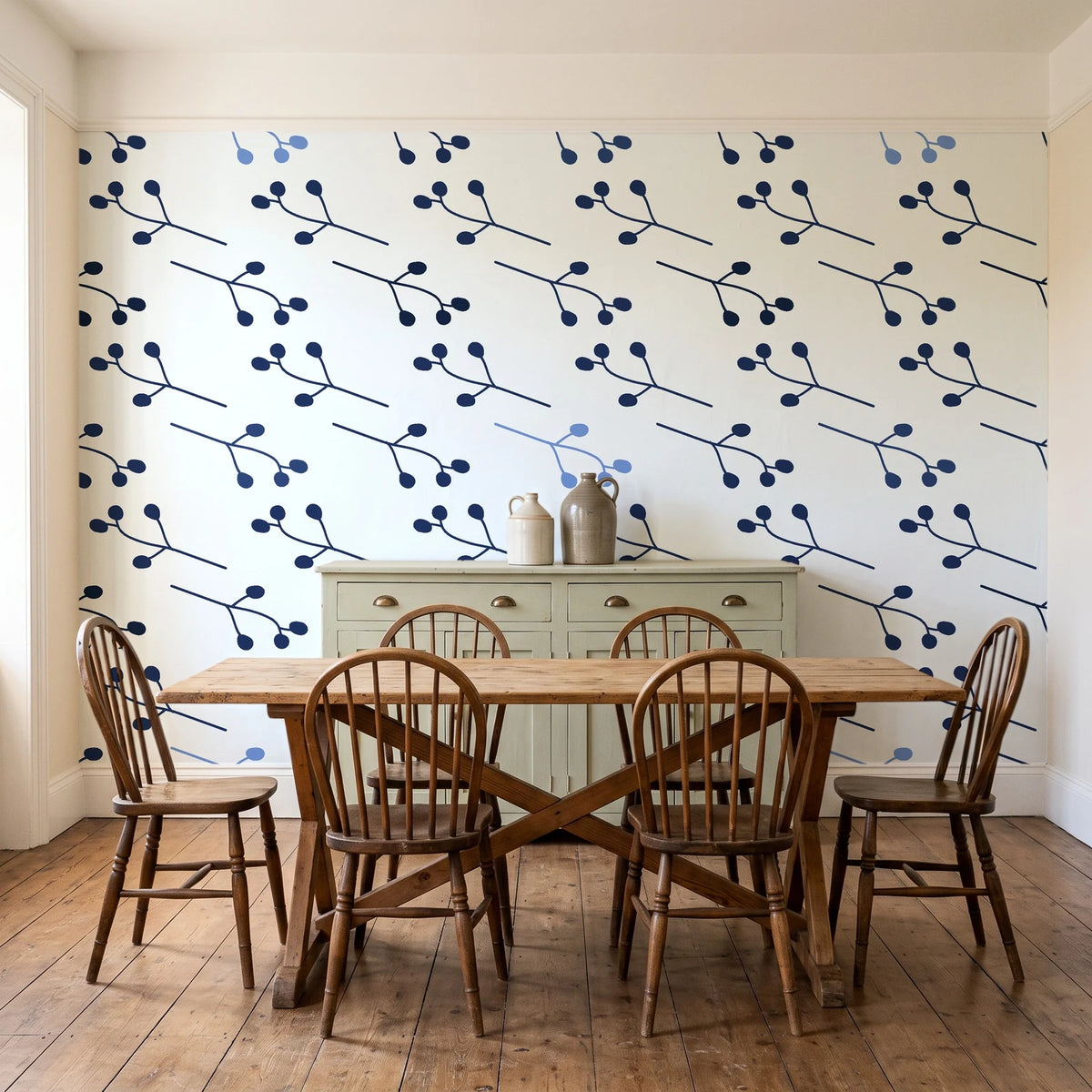 Stone Garden Navy sprig wallpaper in a farmhouse dining room with a sage sideboard and rustic trestle table