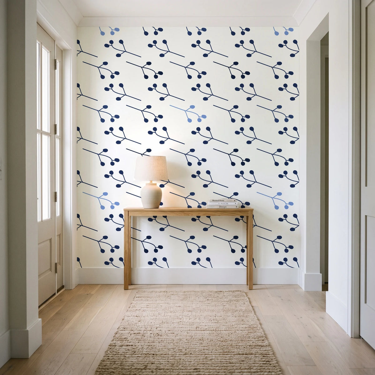 Stone Garden Navy sprig wallpaper behind a console table in a light entry hallway