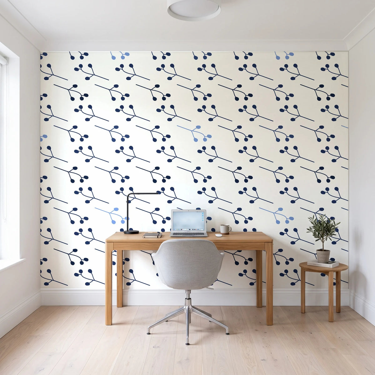Stone Garden Navy sprig wallpaper behind a modern oak desk in a bright home office