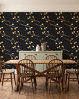 Stone Garden Noir sprig wallpaper in a farmhouse dining room with a sage sideboard and rustic trestle table