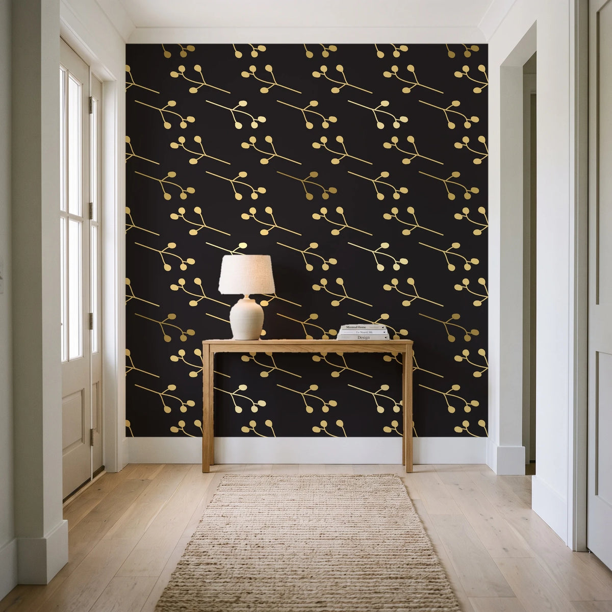 Stone Garden Noir sprig wallpaper behind a console table in a light entry hallway