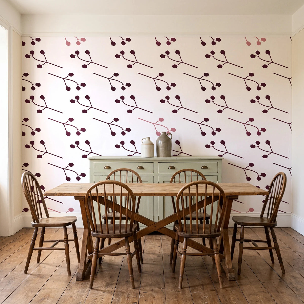 Stone Garden Oxblood sprig wallpaper in a farmhouse dining room with a sage sideboard and rustic trestle table