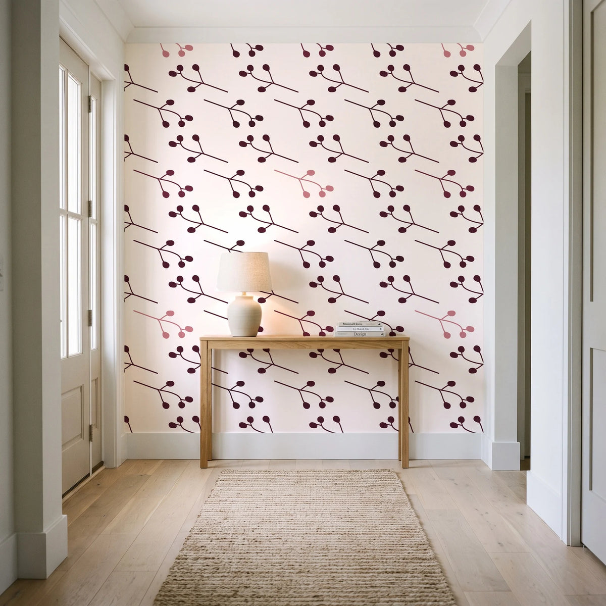 Stone Garden Oxblood sprig wallpaper behind a console table in a light entry hallway