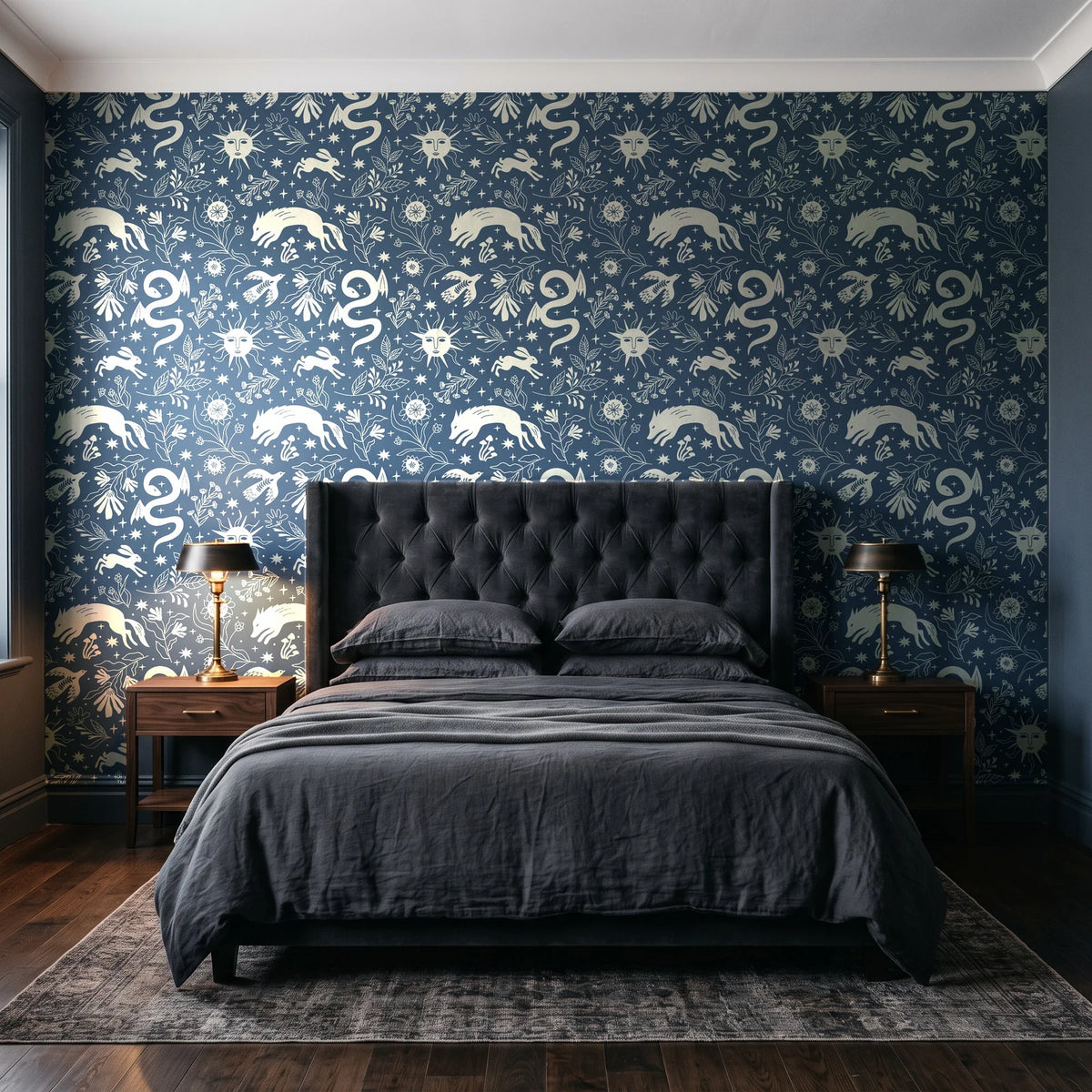 Sun & Moon Slate celestial folk wallpaper behind a tufted headboard in a dark, moody bedroom