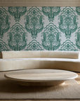 Sunlit Thicket Emerald damask wallpaper in an elegant living room
