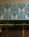 Sunlit Thicket Emerald damask wallpaper in an intimate luxury cocktail lounge